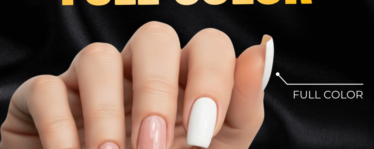 A hand with French Tip and Full Color manicures on a satin background.
